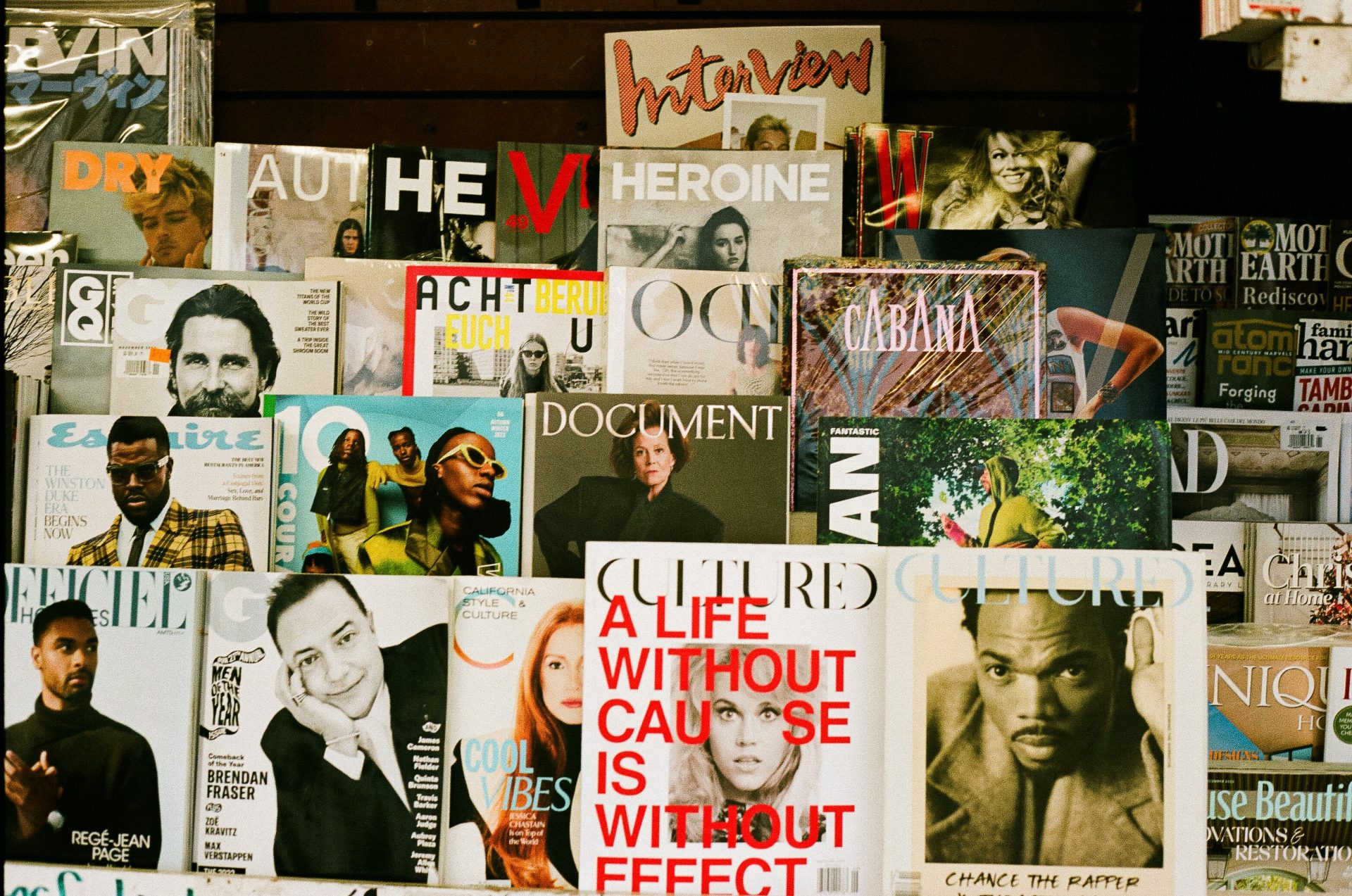 Magazines displayed in a storefront. Authentic Magazine features are examples of earned media.