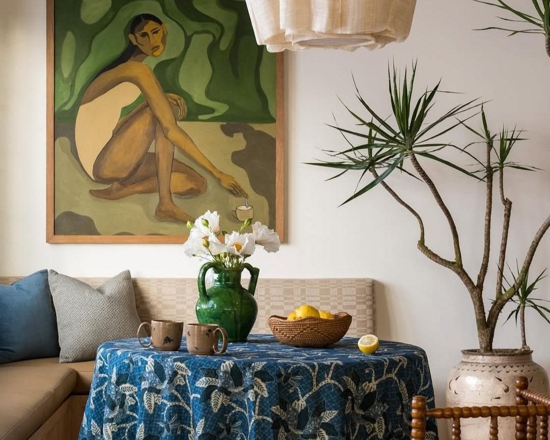 A wellness inspired dining room, featuring soft textile elements, natural materials and plants.